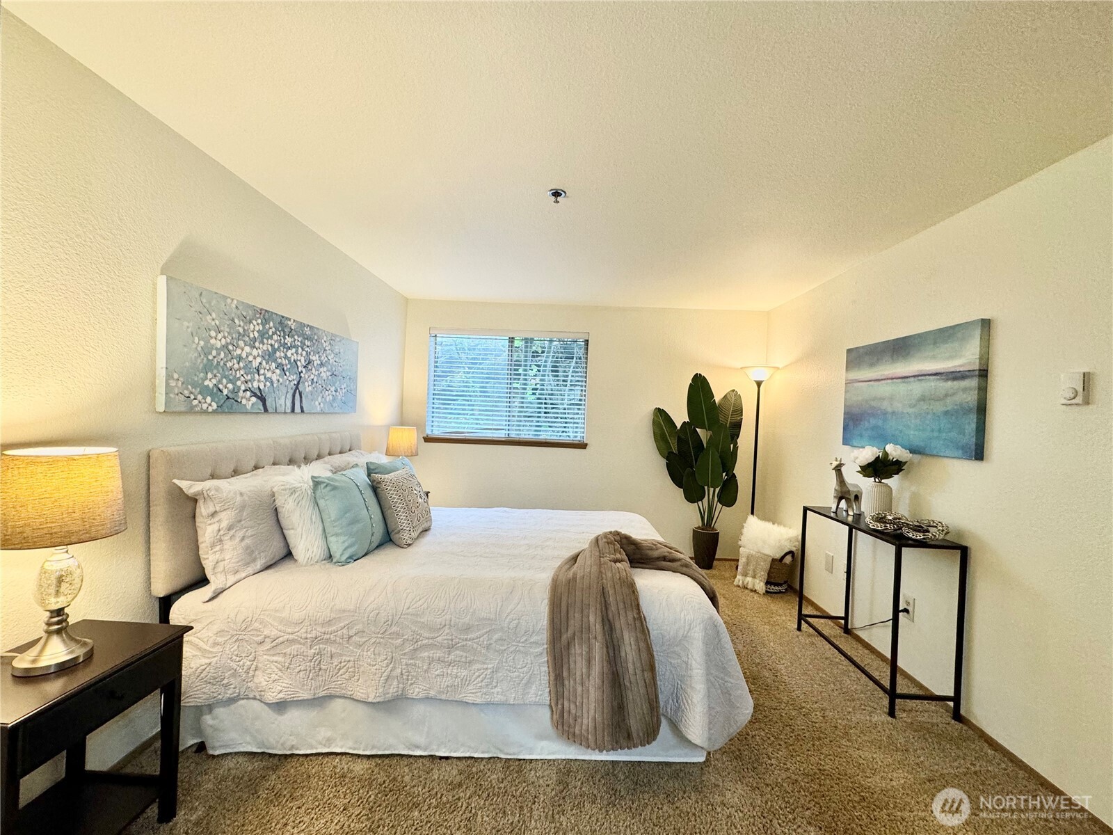 28606 16th Avenue South, Unit 102 Federal Way, WA 98003 - Photo 10 of 22 a bedroom with a bed a mirror and lamp on dresser