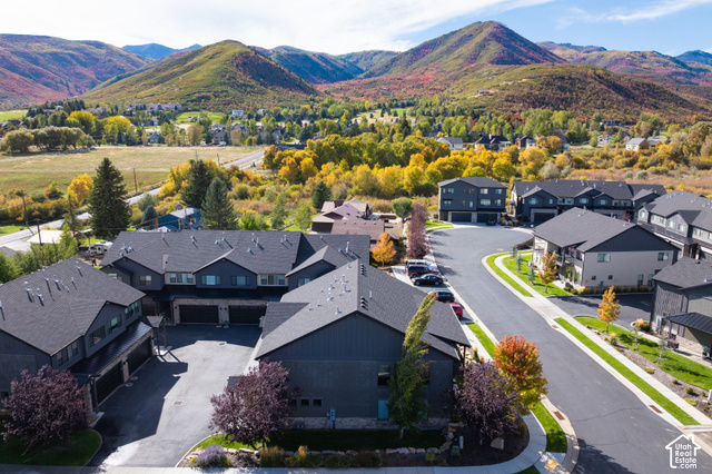 1141 520 West Midway, UT 84049 - Photo 36 of 40 Modern multi-level residences with dark siding and shingle roofs, situated within a developed community featuring paved streets and established landscaping