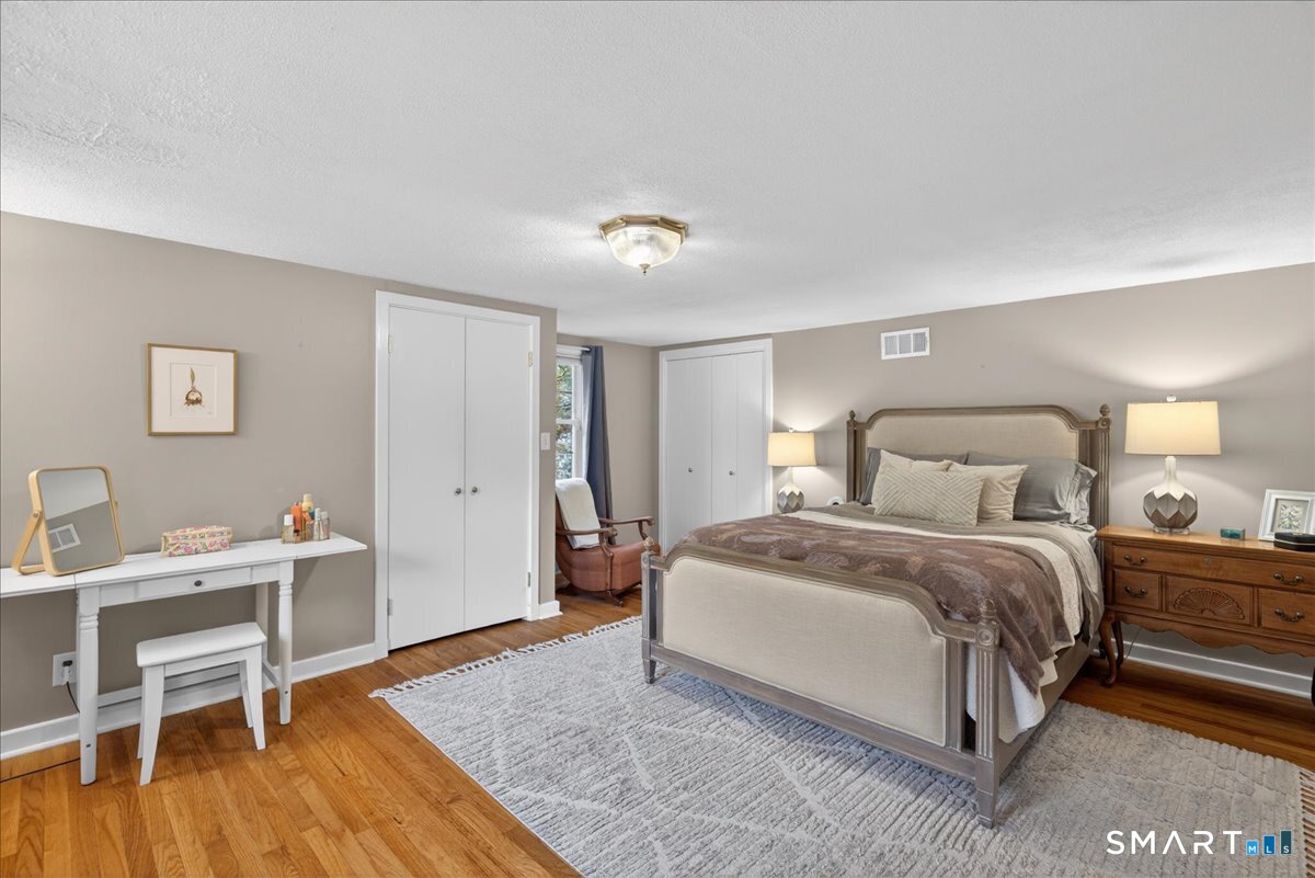 54 Jackson Road Hamden, CT 06517 - Photo 19 of 40 a bedroom with a bed and a table in it