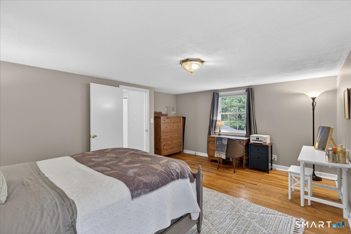 54 Jackson Road Hamden, CT 06517 - Photo 20 of 40 a bedroom with a bed a table window and chair