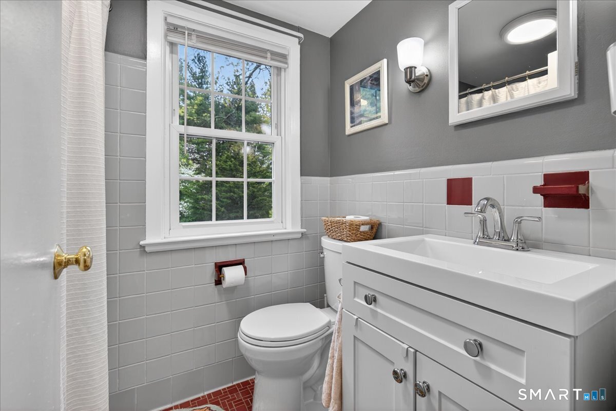 54 Jackson Road Hamden, CT 06517 - Photo 21 of 40 a bathroom with a sink a toilet and a window