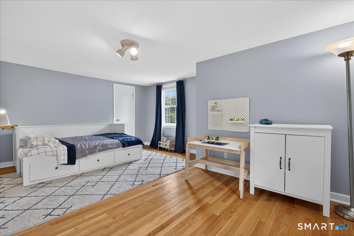 54 Jackson Road Hamden, CT 06517 - Photo 22 of 40 a living room with furniture and a wooden floor