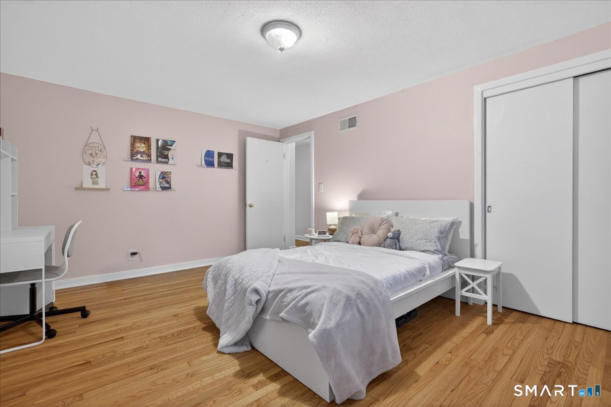 54 Jackson Road Hamden, CT 06517 - Photo 25 of 40 a bedroom with a bed and a chair