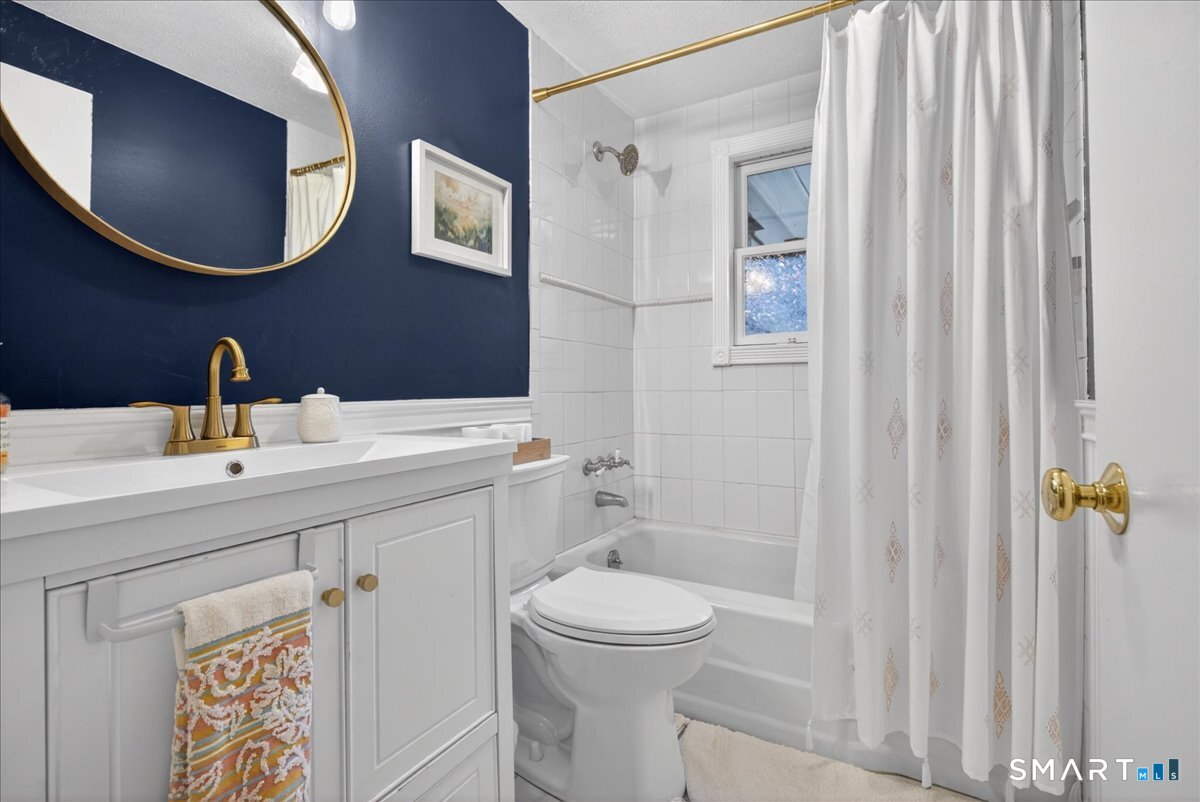 54 Jackson Road Hamden, CT 06517 - Photo 28 of 40 a bathroom with a toilet sink and mirror