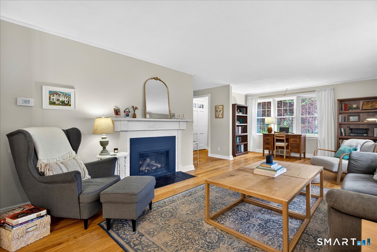 54 Jackson Road Hamden, CT 06517 - Photo 4 of 40 a living room with furniture a fireplace and a table