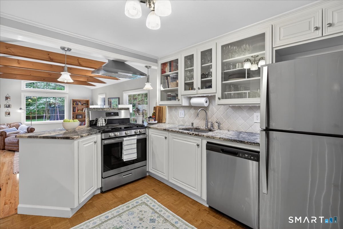 54 Jackson Road Hamden, CT 06517 - Photo 10 of 40 a kitchen with stainless steel appliances granite countertop a stove and a refrigerator