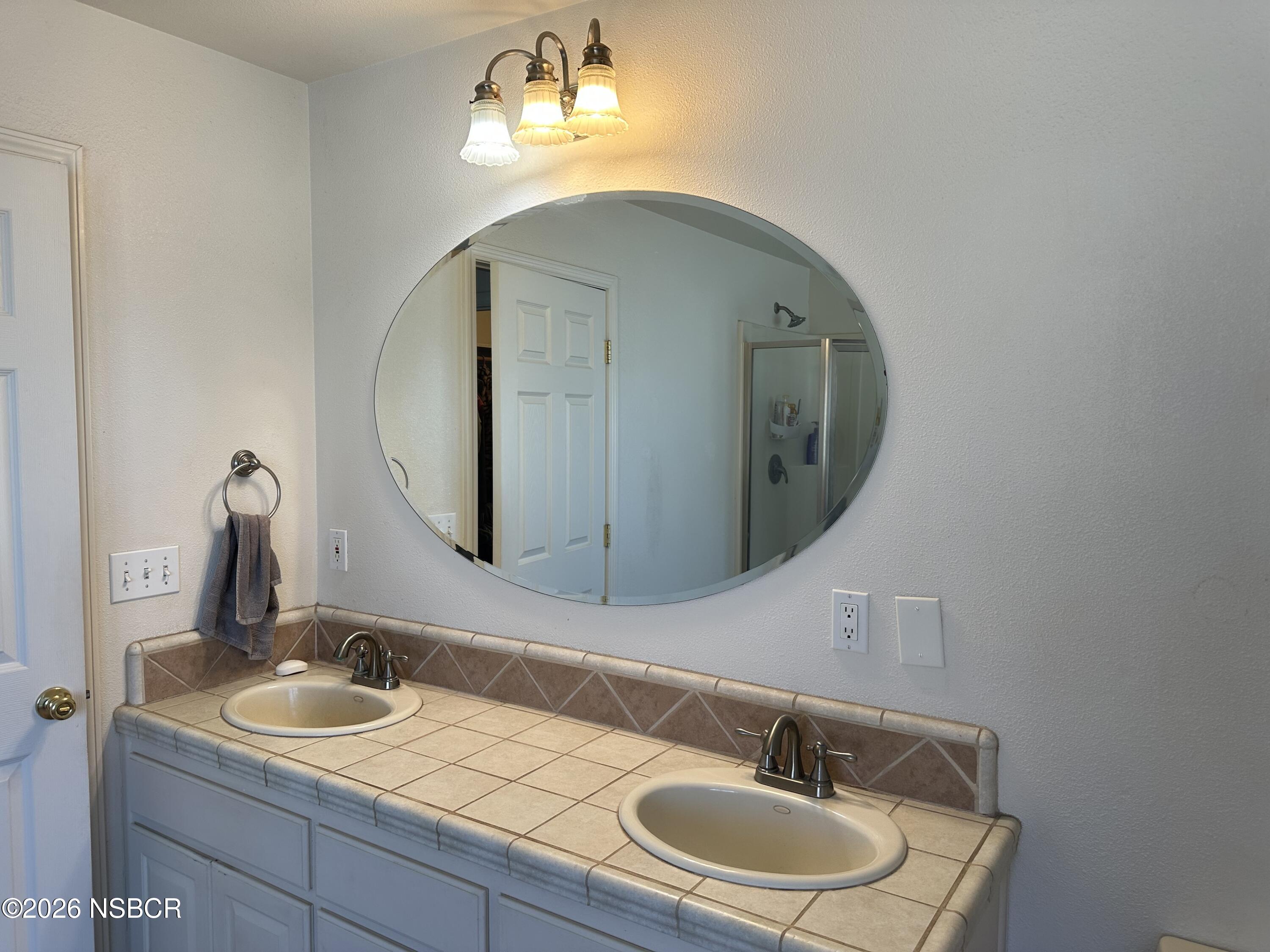 192 East Branch Street Nipomo, CA 93444 - Photo 16 of 26 a bathroom with a sink and a mirror
