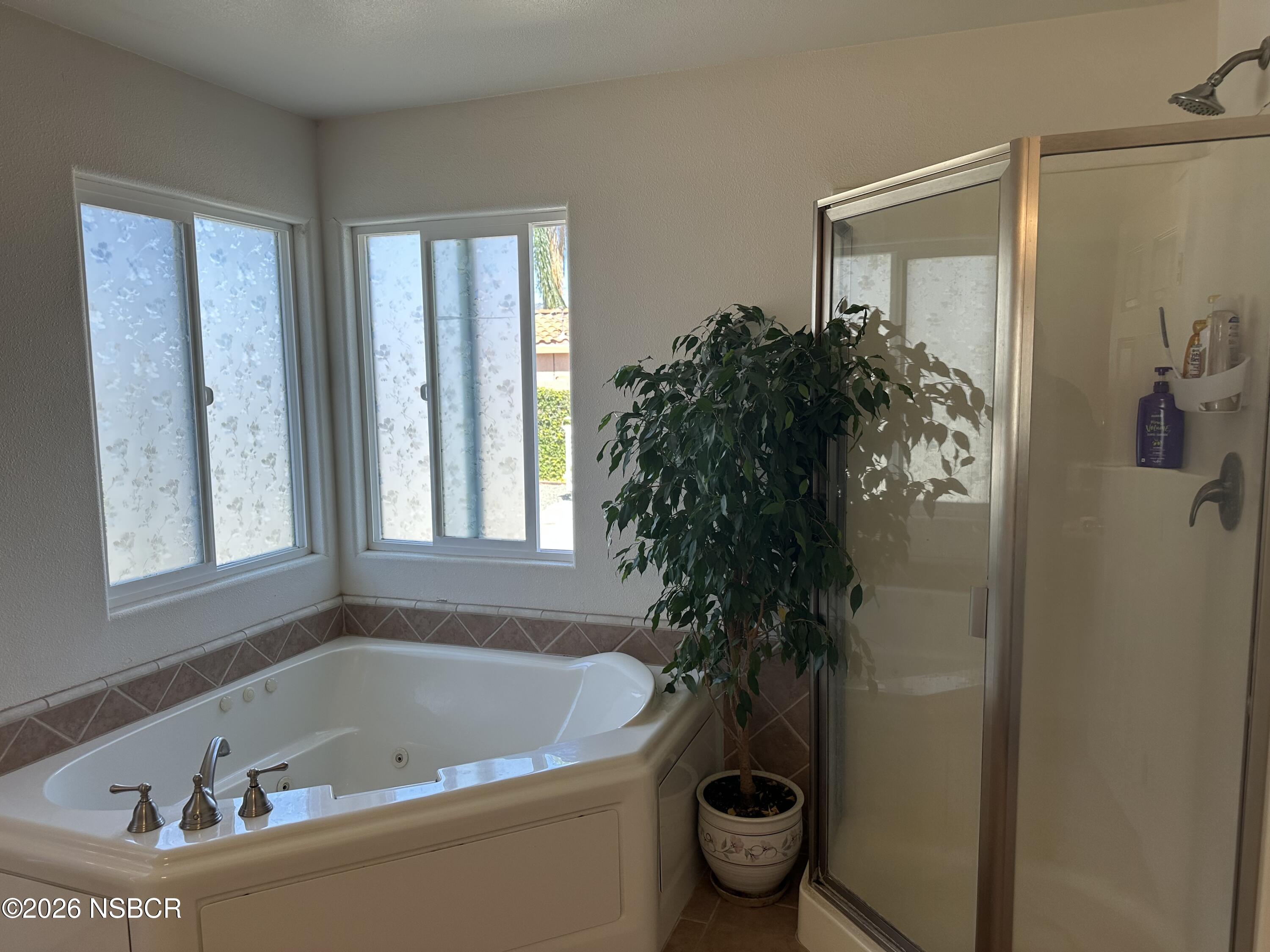 192 East Branch Street Nipomo, CA 93444 - Photo 18 of 26 a bath tub sitting in a bathroom next to a window