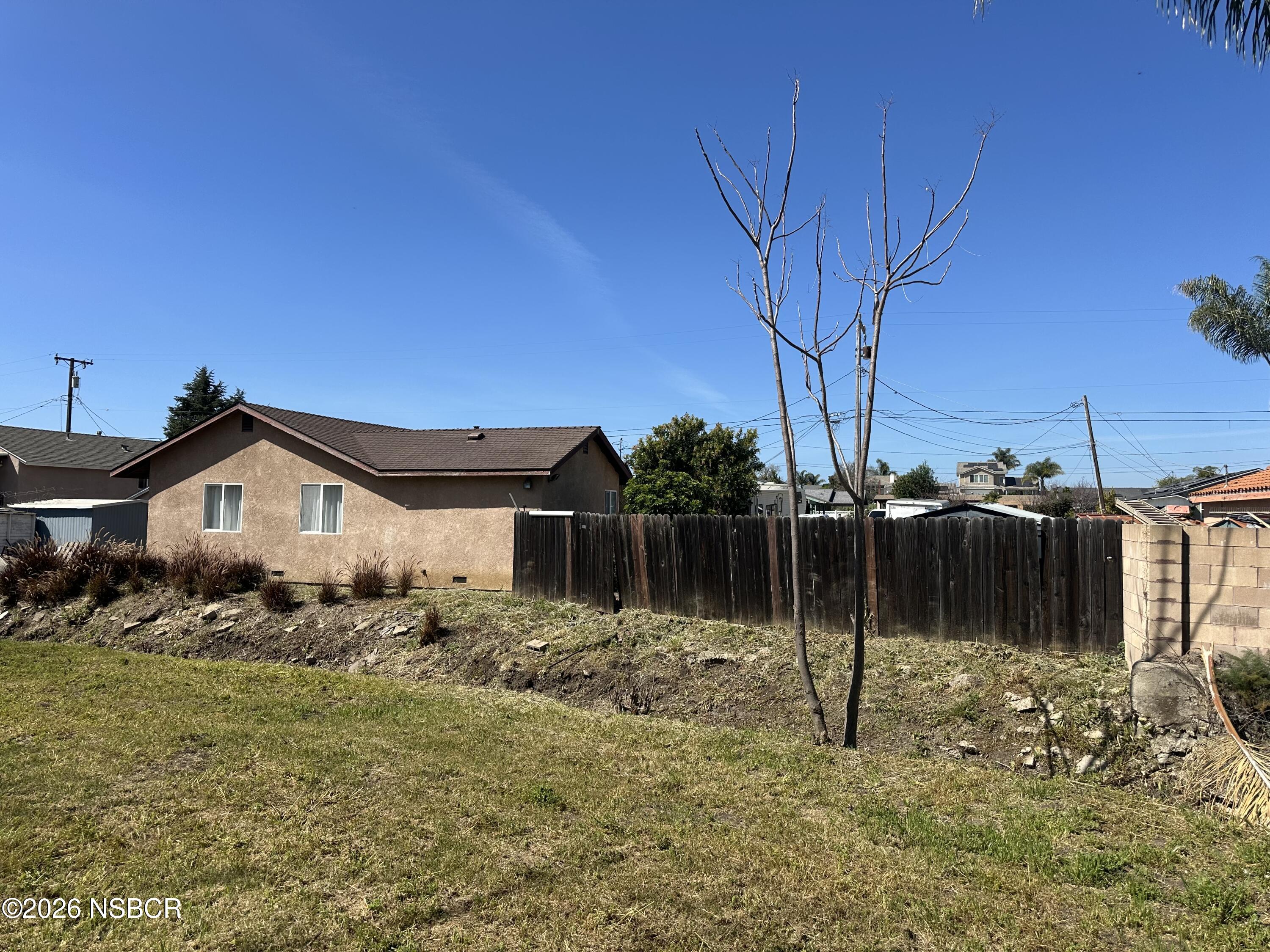 192 East Branch Street Nipomo, CA 93444 - Photo 2 of 26 a backyard of a house with lots of green space