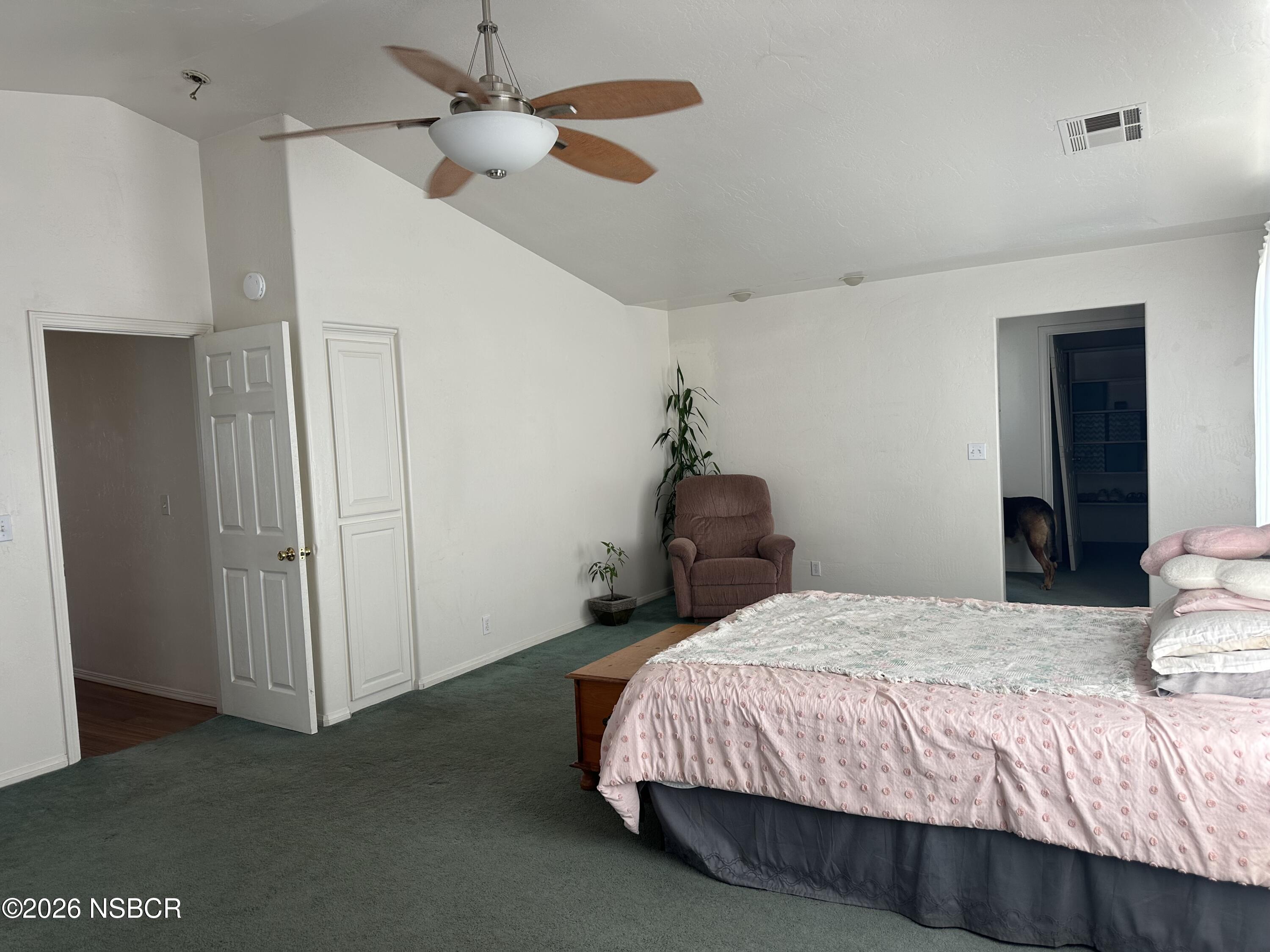 192 East Branch Street Nipomo, CA 93444 - Photo 21 of 26 a bedroom with a bed and a chandelier