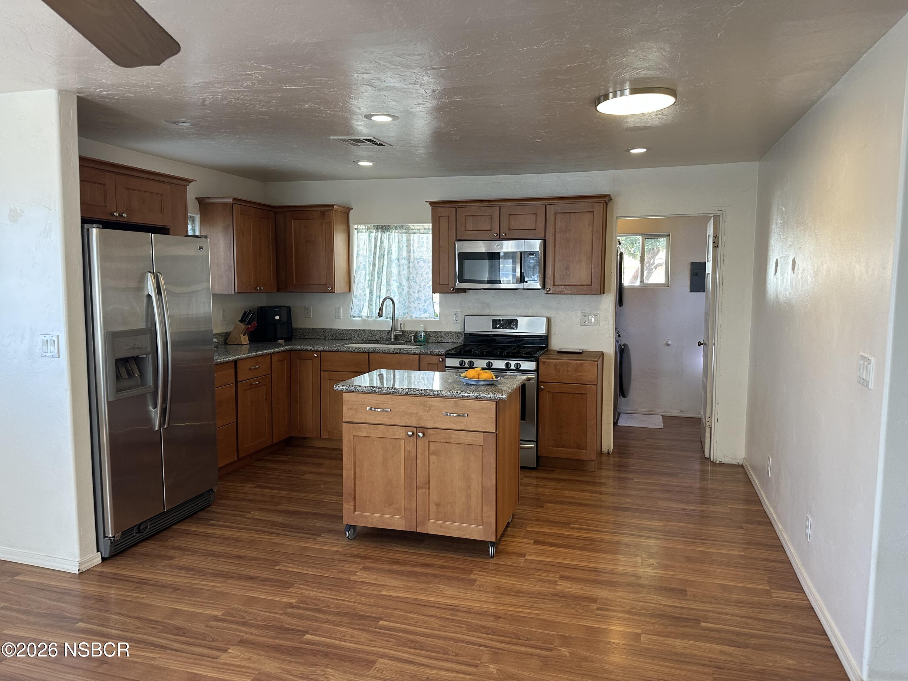 192 East Branch Street Nipomo, CA 93444 - Photo 9 of 26 a kitchen with stainless steel appliances granite countertop a stove a sink and a refrigerator