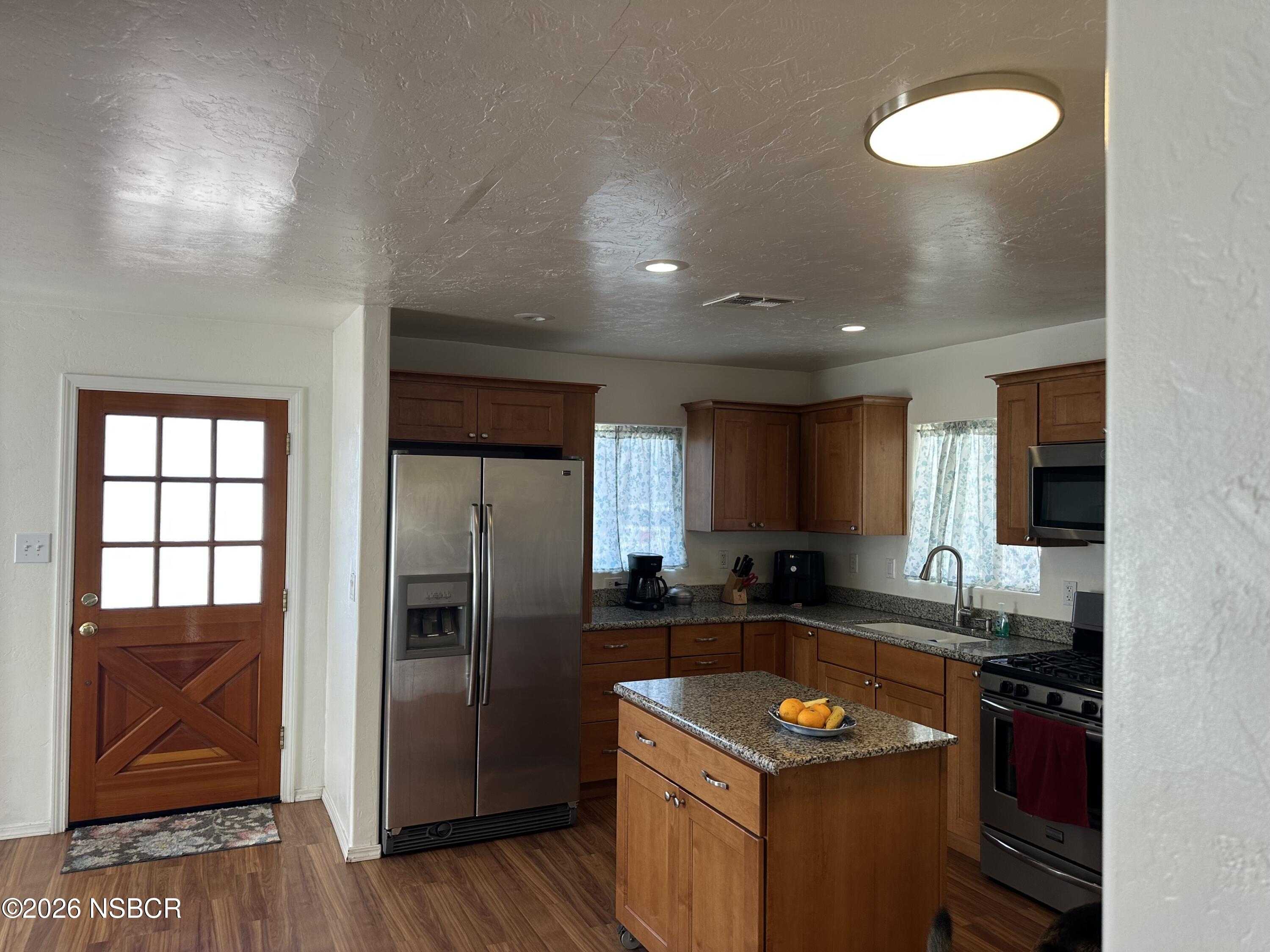 192 East Branch Street Nipomo, CA 93444 - Photo 10 of 26 a kitchen with granite countertop a refrigerator and a sink