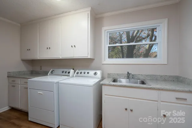 a view of cabinets and washer dryer