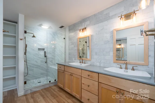 a bathroom with a shower sink and mirror