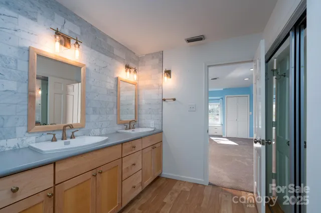 a bathroom with a double vanity sink and a mirror