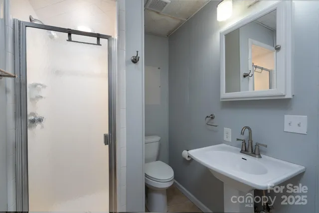 a bathroom with a sink toilet and mirror
