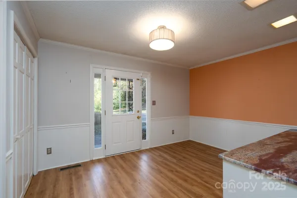 a view of empty room with wooden floor
