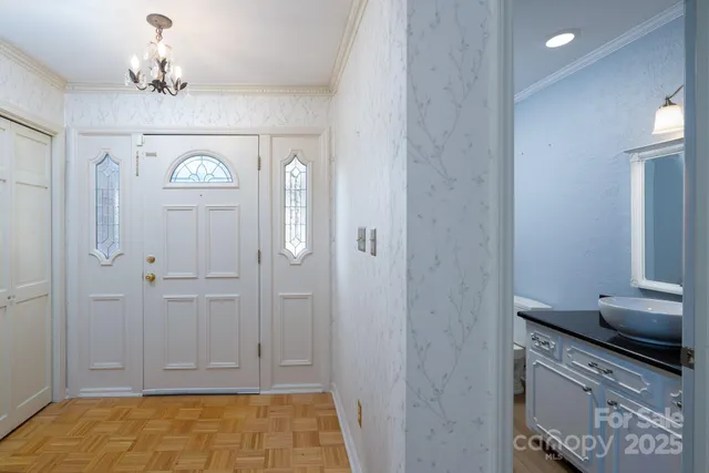 a view of a hallway with chandelier