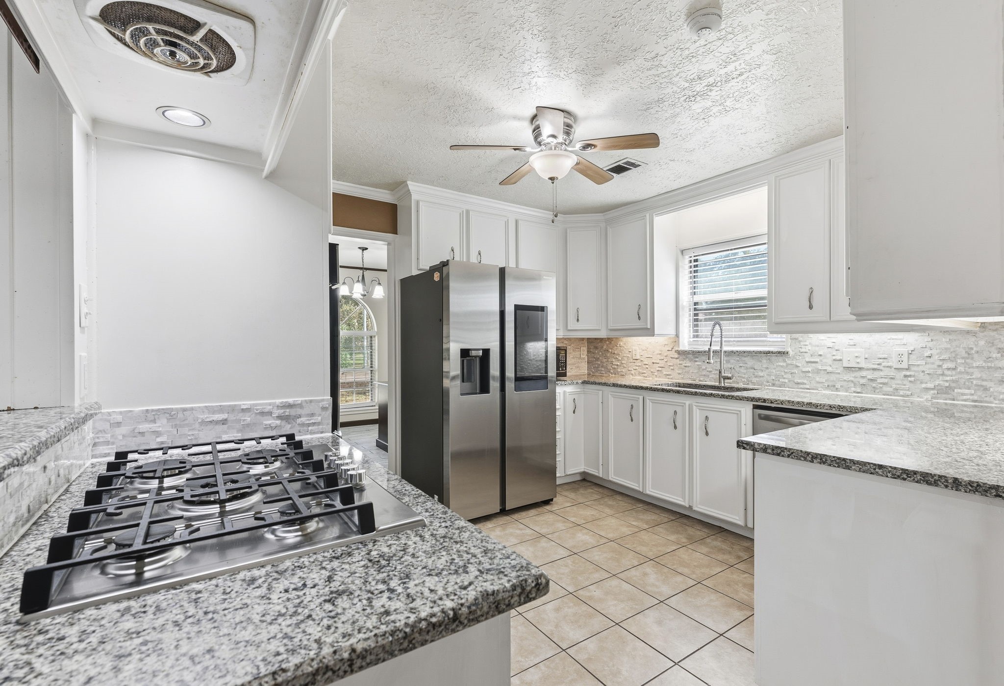 17603 Loring Lane Spring, TX 77388 - Photo 13 of 50 a kitchen with stainless steel appliances granite countertop a sink stove and refrigerator