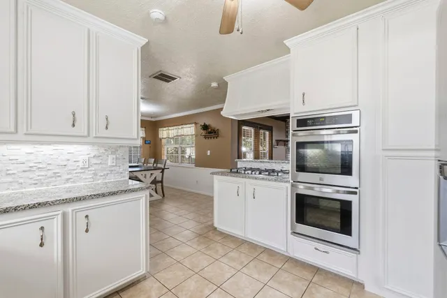a kitchen with cabinets and oven