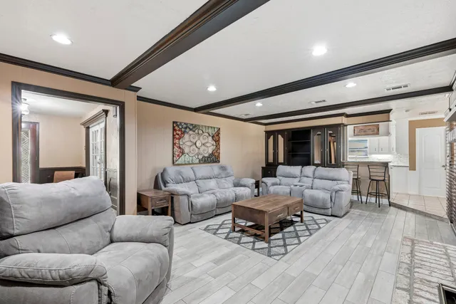 a living room with furniture and wooden floor