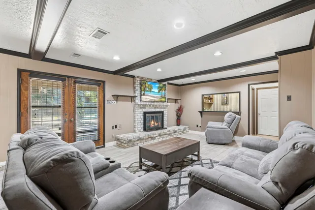 a living room with furniture large window and a fireplace