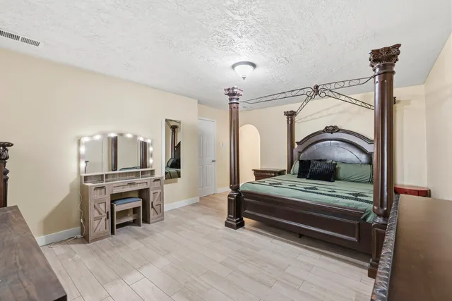 a bedroom with furniture and a chandelier