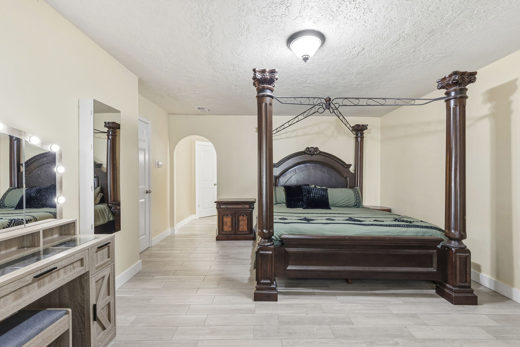 17603 Loring Lane Spring, TX 77388 - Photo 26 of 50 a bedroom with a bed table and flat screen tv