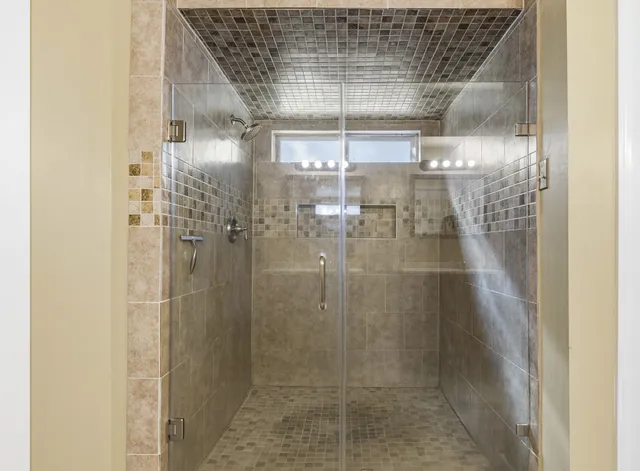a bathroom with a glass shower door