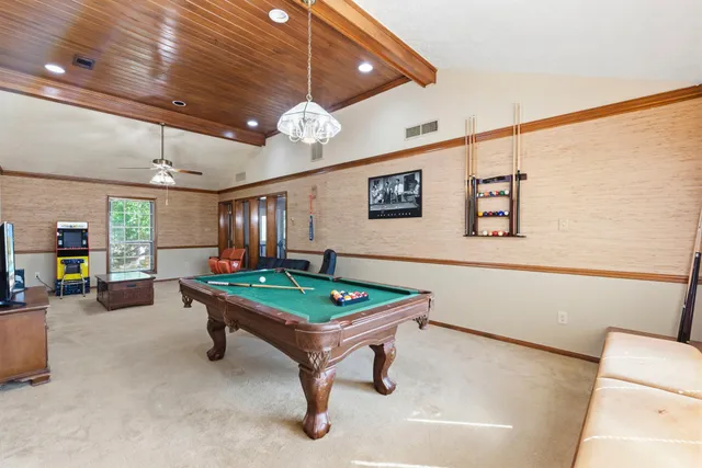 a room with furniture and pool table