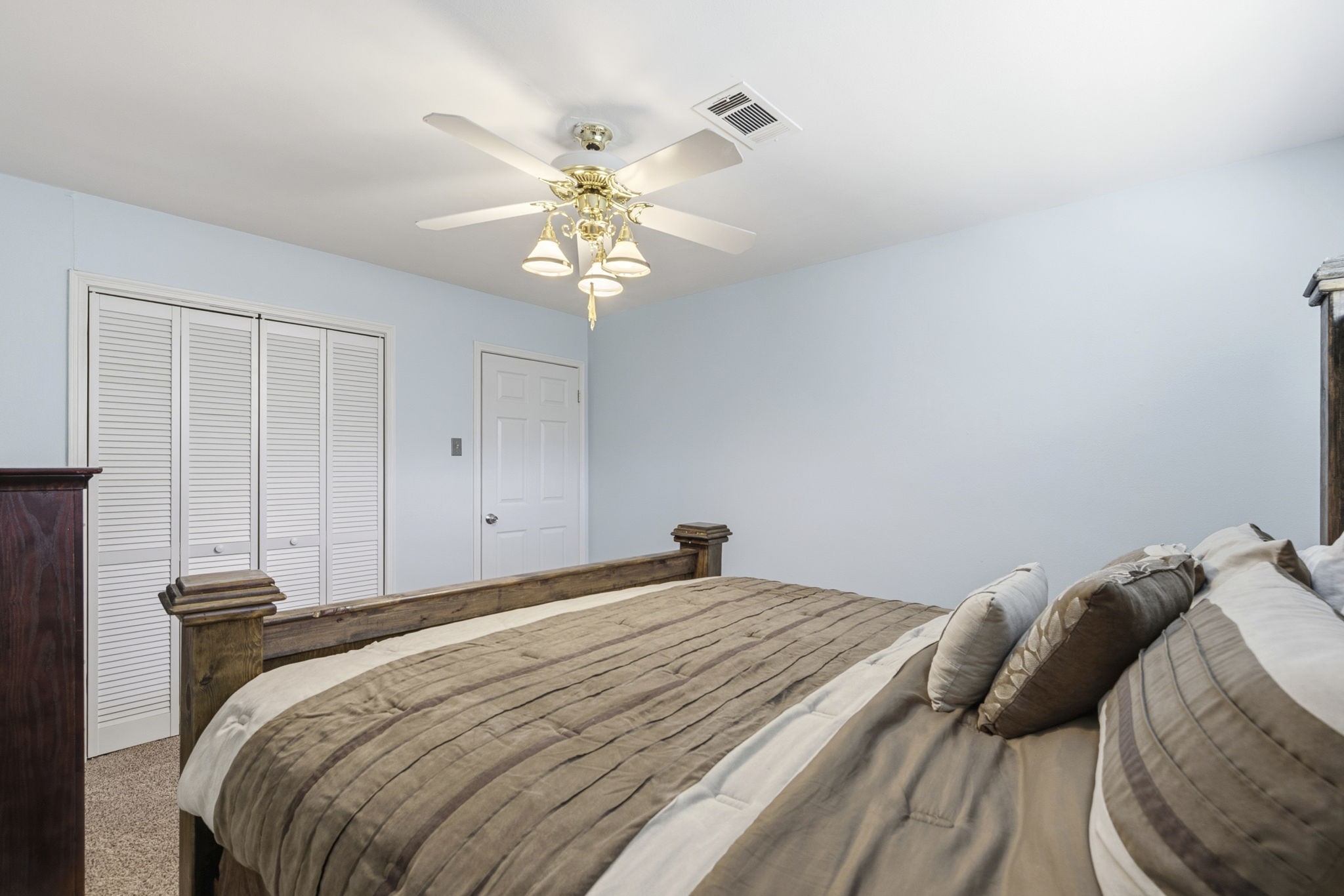 17603 Loring Lane Spring, TX 77388 - Photo 37 of 50 a bedroom with a bed and a chandelier
