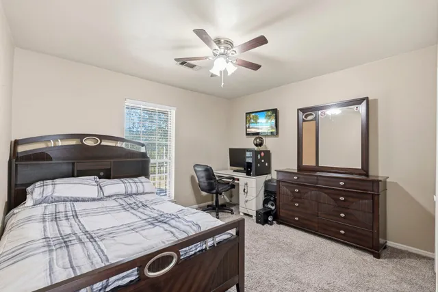 a bedroom with a bed and a dresser