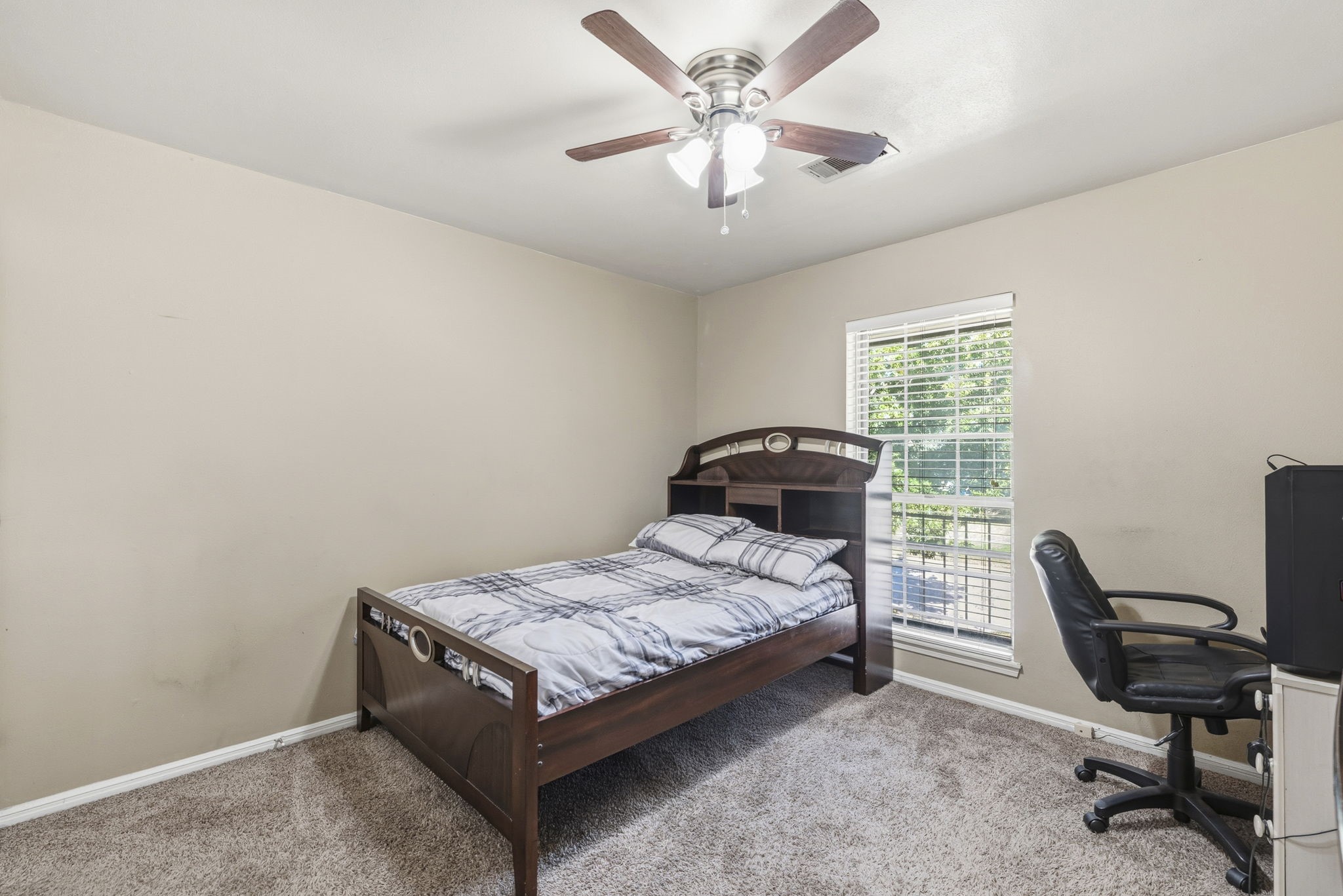 17603 Loring Lane Spring, TX 77388 - Photo 42 of 50 a bedroom with a bed and a chandelier