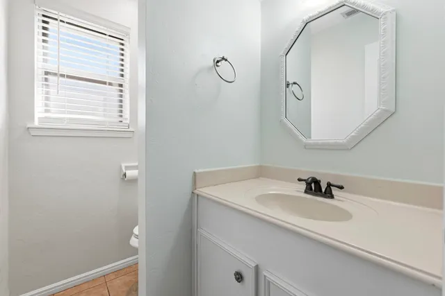 a bathroom with a sink and mirror with vanity