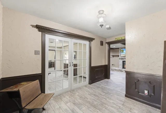 a spacious bedroom with a bed and a television