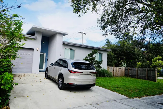 a view of a car parked in front of a house