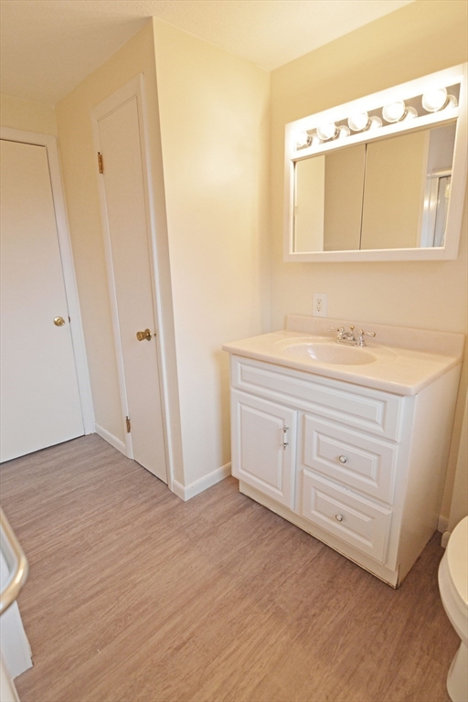 122 Garnet Street Springfield, MA 01129 - Photo 18 of 36 a bathroom with a sink a toilet and a mirror
