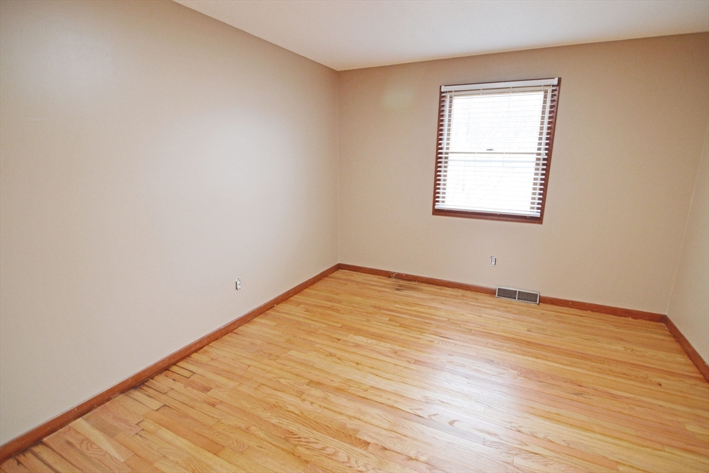 122 Garnet Street Springfield, MA 01129 - Photo 20 of 36 an empty room with wooden floor and windows