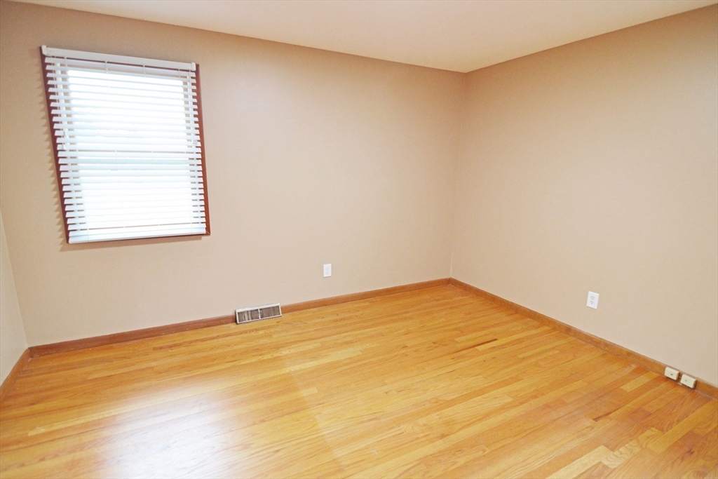 122 Garnet Street Springfield, MA 01129 - Photo 23 of 36 a view of an empty room with wooden floor and a window