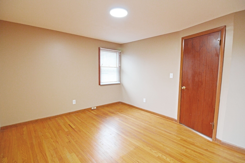 122 Garnet Street Springfield, MA 01129 - Photo 24 of 36 an empty room with wooden floor and windows