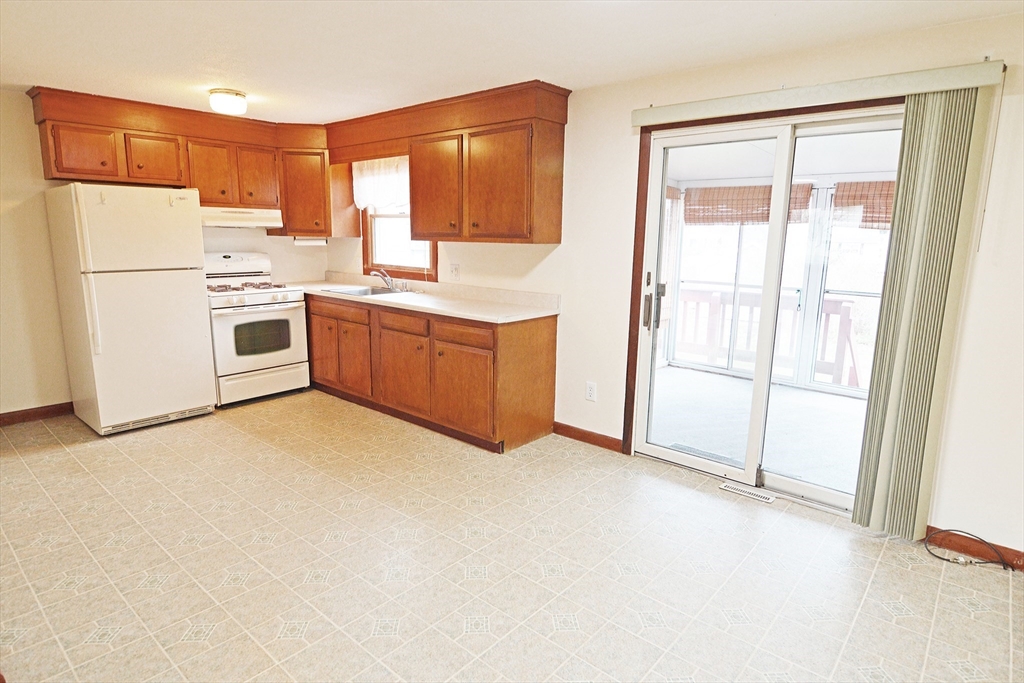 122 Garnet Street Springfield, MA 01129 - Photo 5 of 36 a kitchen with stainless steel appliances a refrigerator sink and cabinets
