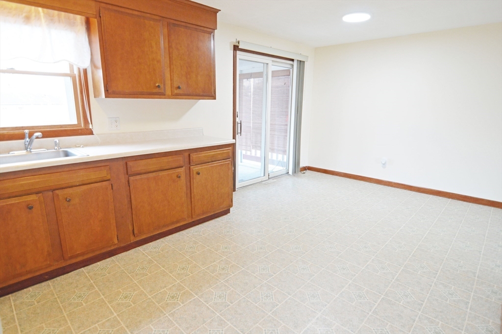 122 Garnet Street Springfield, MA 01129 - Photo 8 of 36 a kitchen with granite countertop white cabinets and sink