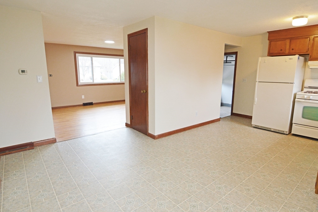 122 Garnet Street Springfield, MA 01129 - Photo 10 of 36 an empty room with a refrigerator and a window