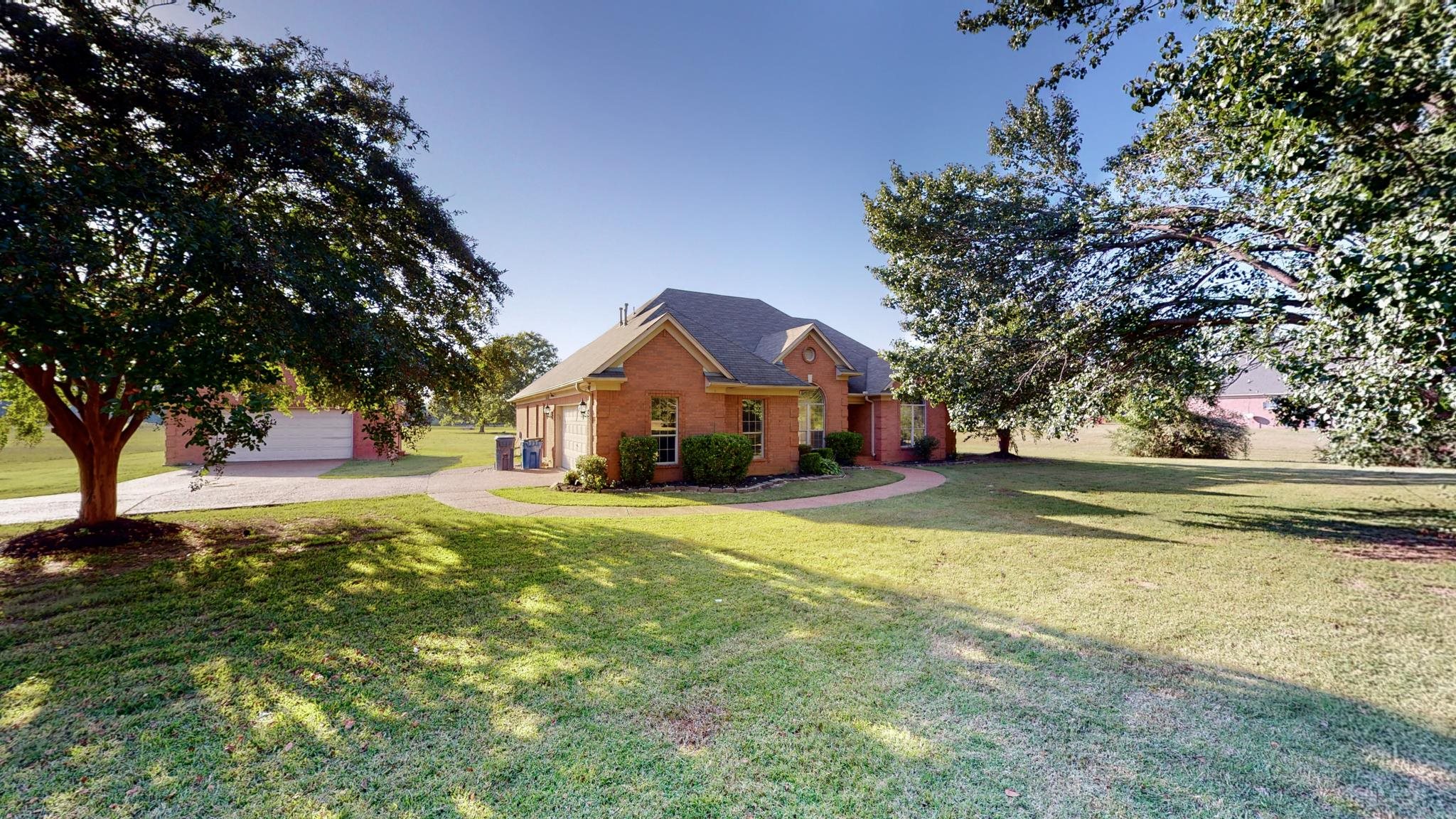 8629 Brunswick Road Millington, TN 38053 - Photo 1 of 25 a front view of a house with a yard