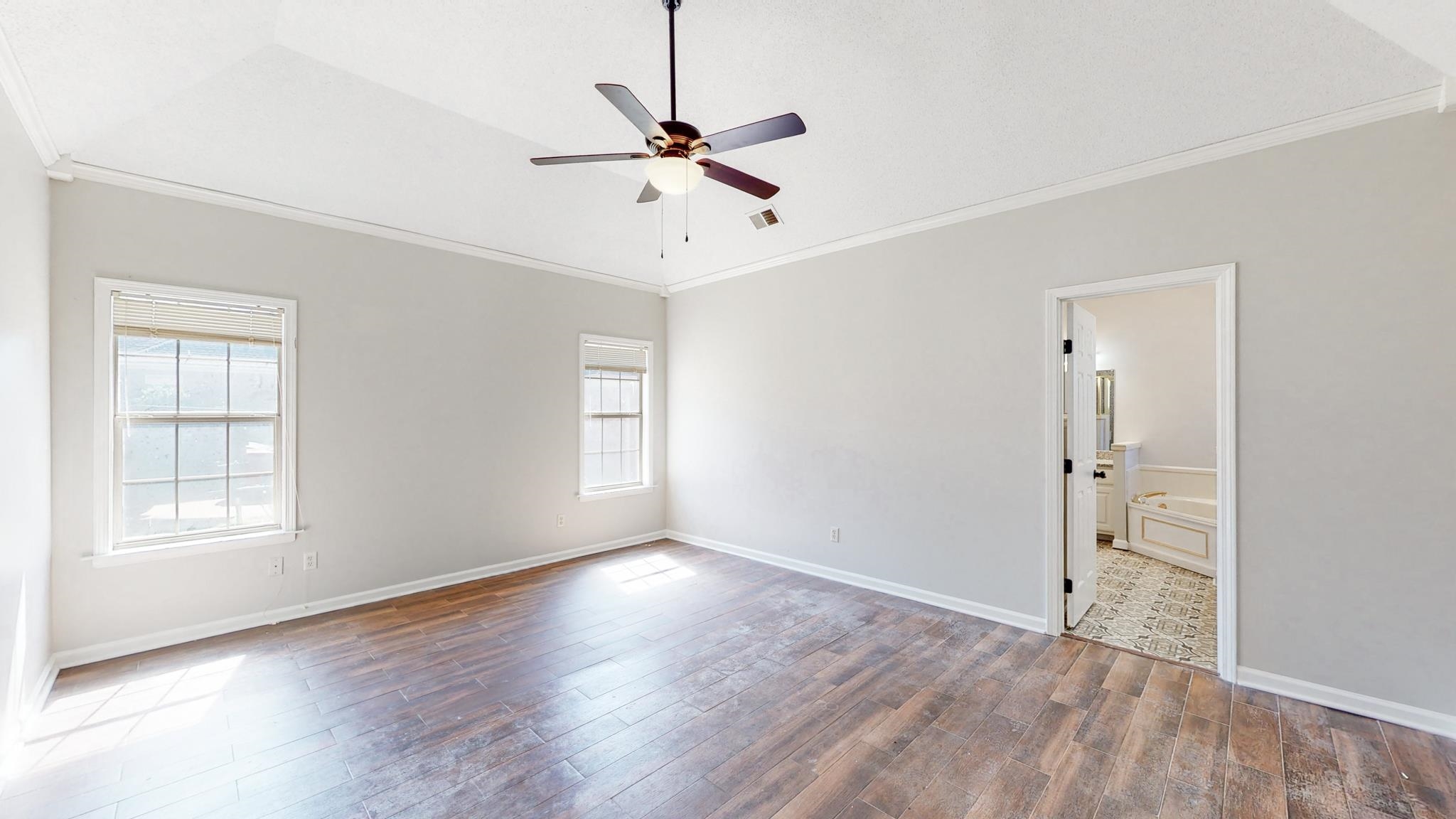 8629 Brunswick Road Millington, TN 38053 - Photo 11 of 25 wooden floor in an empty room with a window
