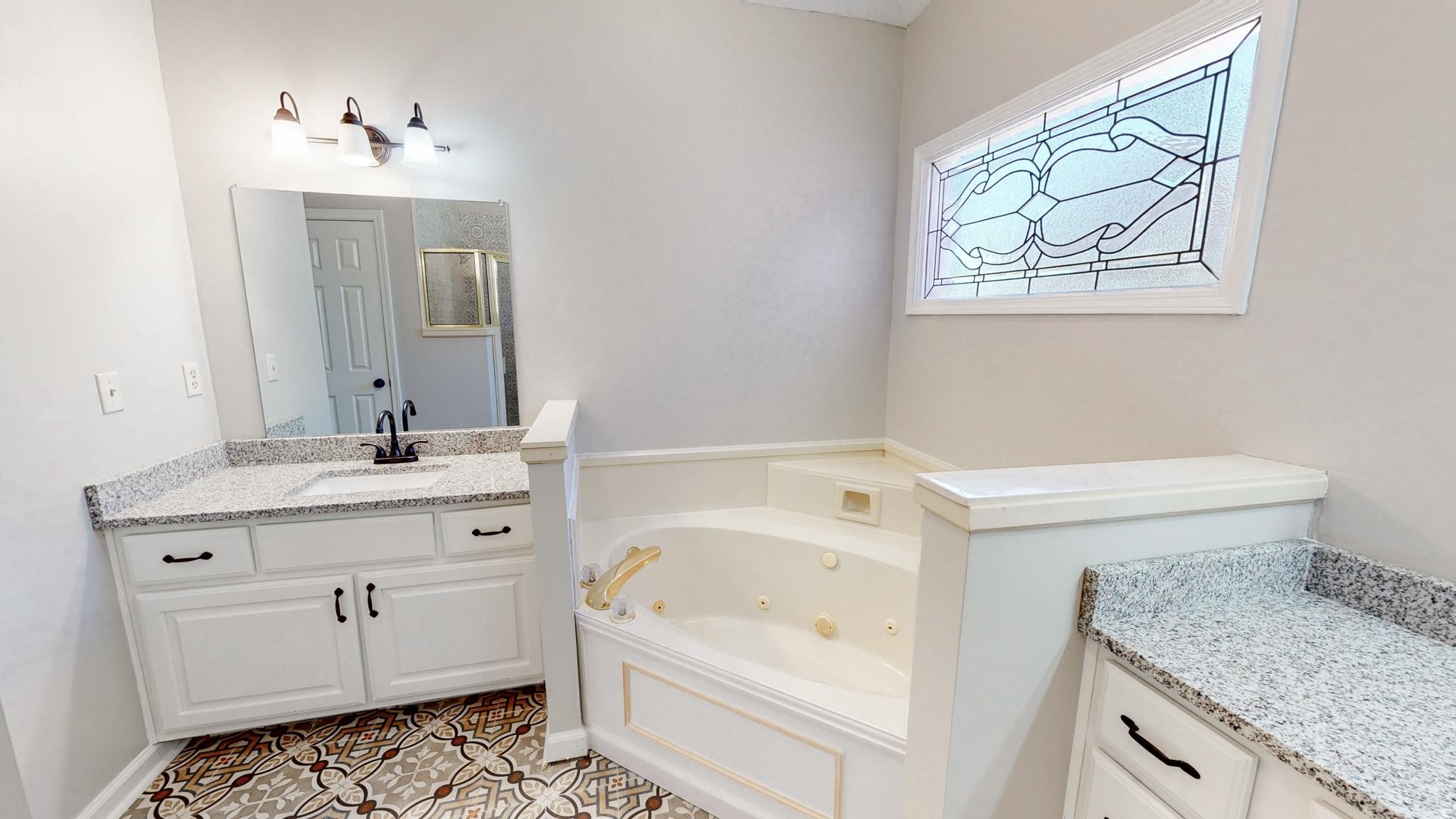 8629 Brunswick Road Millington, TN 38053 - Photo 13 of 25 a bathroom with a granite countertop sink a toilet and bathtub