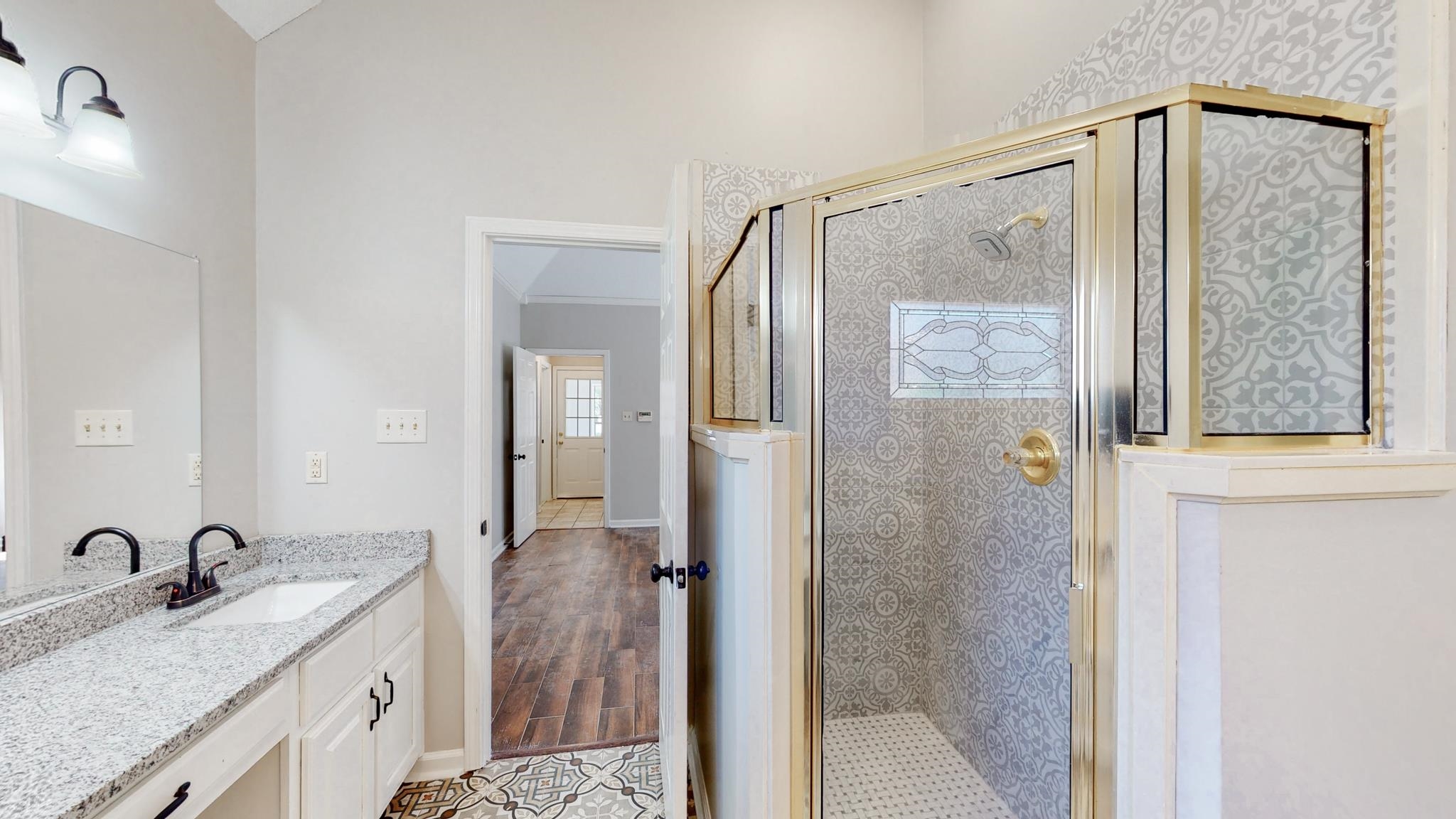 8629 Brunswick Road Millington, TN 38053 - Photo 14 of 25 a bathroom with a granite countertop shower sink and mirror