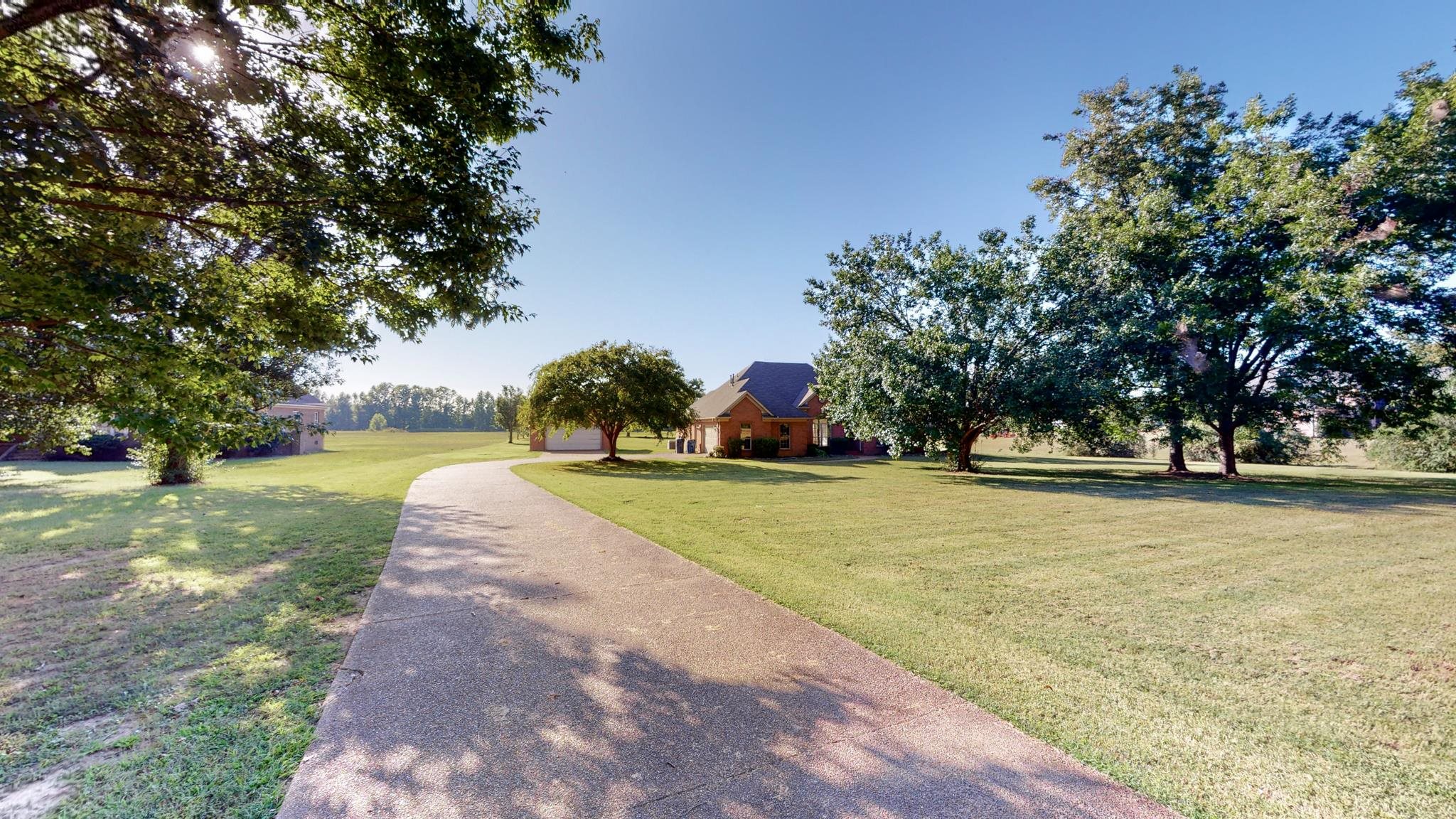 8629 Brunswick Road Millington, TN 38053 - Photo 2 of 25 a view of a yard with plants and trees