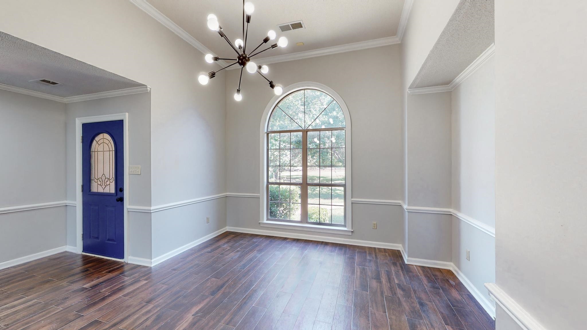 8629 Brunswick Road Millington, TN 38053 - Photo 4 of 25 an empty room with wooden floor and window