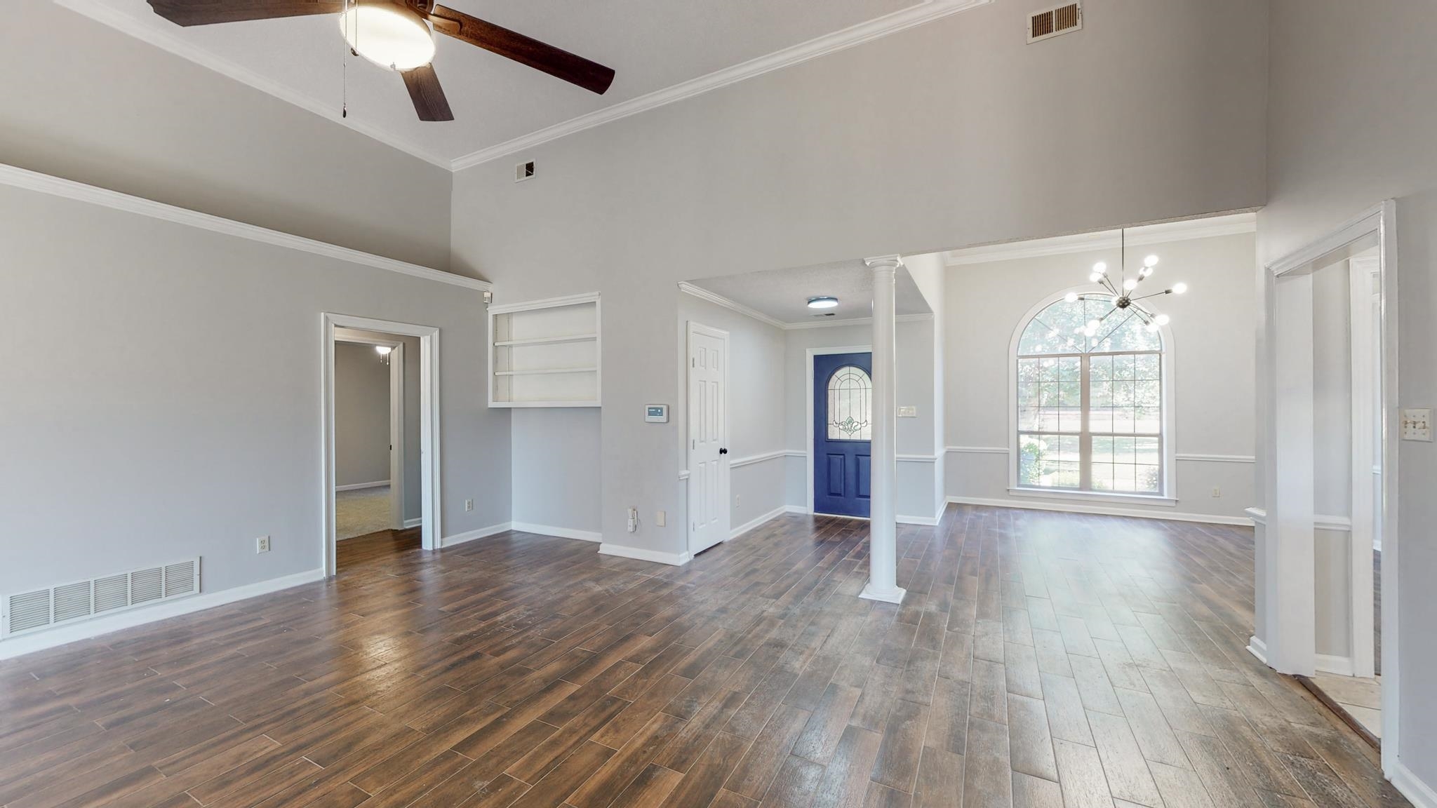 8629 Brunswick Road Millington, TN 38053 - Photo 5 of 25 a view of an empty room with wooden floor and a window